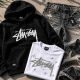 Stussy hoodie, Tenis Amiri sneakers, and Mixed Emotions rhinestone tee laid flat on a concrete surface